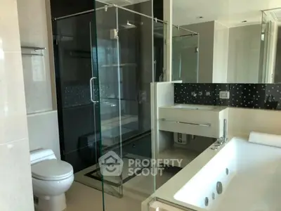 Luxurious modern bathroom with glass shower and jacuzzi tub