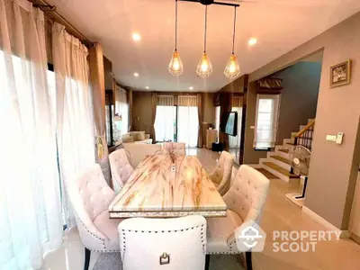 Elegant dining area with modern lighting and plush seating in a stylish home interior