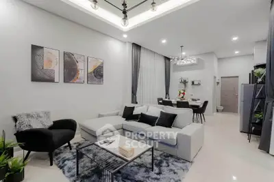 Modern living room with stylish decor and open layout, featuring a cozy seating area and elegant lighting.