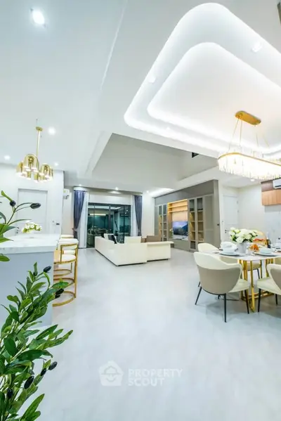 Luxurious open-plan living room with modern decor and elegant lighting