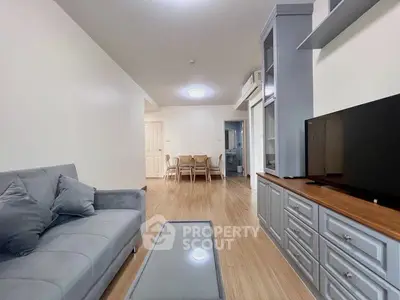 Spacious living room with modern decor and sleek furniture in a stylish apartment.