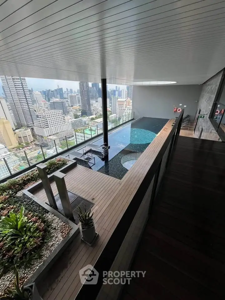 Luxurious rooftop pool with stunning city skyline view in modern high-rise building.