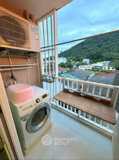 Charming balcony with laundry area and scenic mountain view, perfect for urban living.