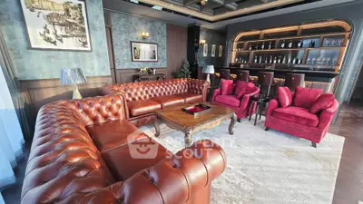 Luxurious living room with leather sofas and elegant bar area, perfect for entertaining guests.