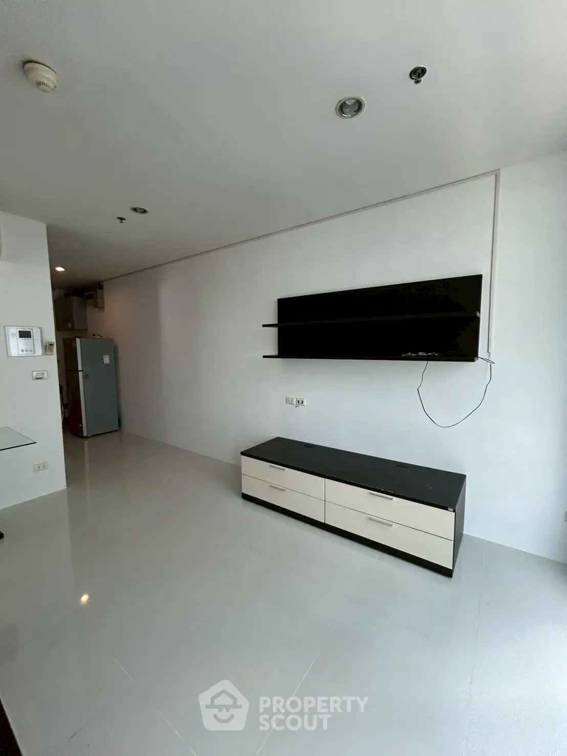 Modern minimalist living room with sleek TV stand and wall-mounted screen