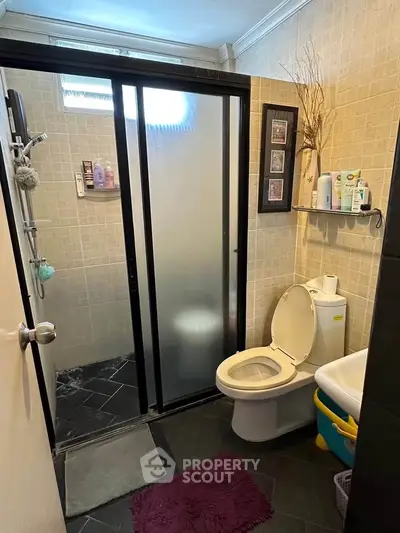 Cozy bathroom with modern shower and toilet, perfect for a compact home.
