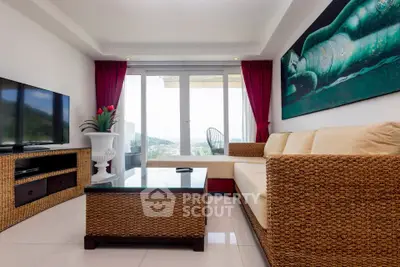 Spacious living room with modern decor and large windows offering scenic views.