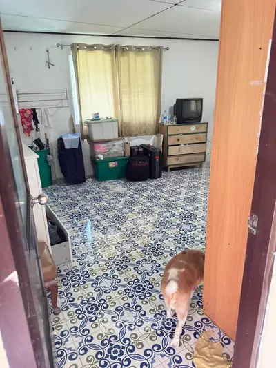 Charming room with vintage tile flooring and cozy decor, perfect for a personal touch.