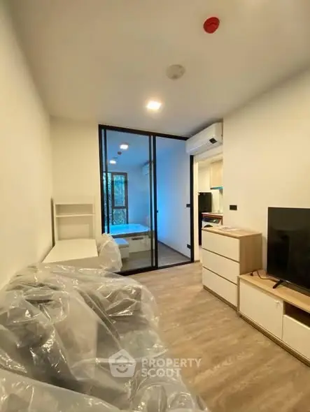 Modern apartment interior with glass partition and cozy furnishings