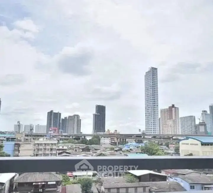 Stunning cityscape view from a high-rise balcony showcasing urban skyline and modern architecture.