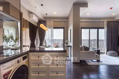 Modern open-plan living room with kitchen and balcony view in a stylish apartment.