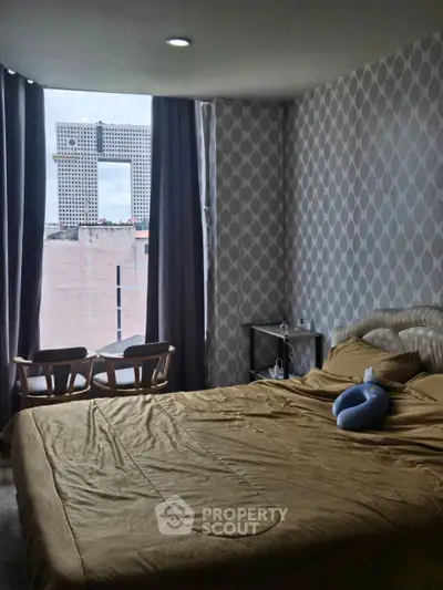 Cozy bedroom with modern decor and large window view