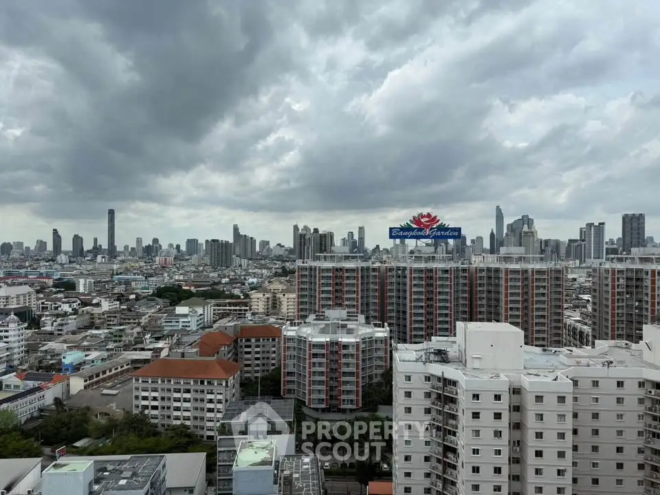 Stunning cityscape view from a high-rise building in Bangkok, showcasing urban skyline and dramatic clouds.