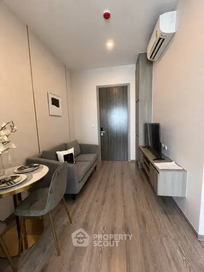 Modern living room with sleek furniture and air conditioning in a stylish apartment.