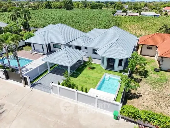 Luxurious modern villa with private pool and lush garden in serene countryside setting.