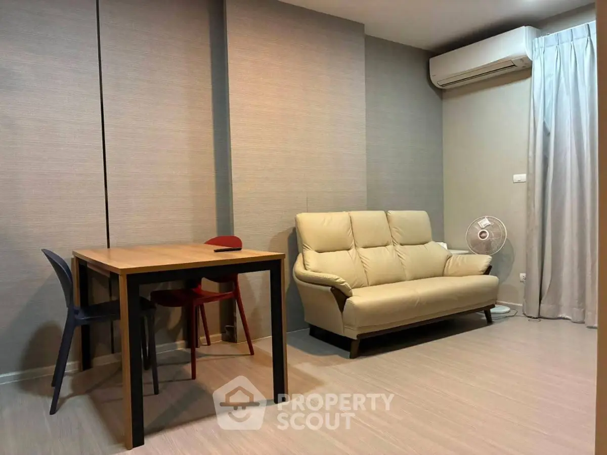 Modern living room with sleek furniture and air conditioning unit