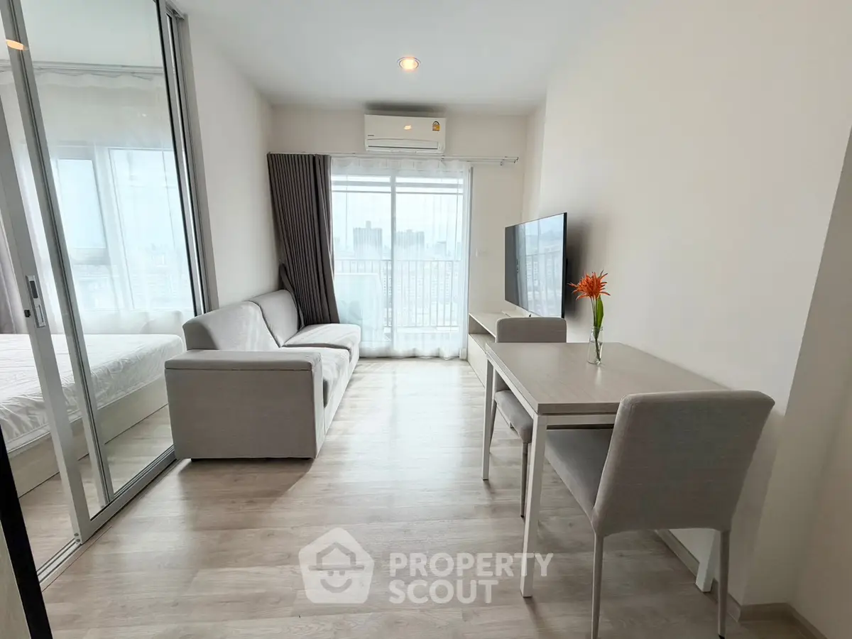 Modern living room with sleek furniture and city view, perfect for urban living.