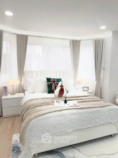 Bright and cozy bedroom with modern decor and large windows