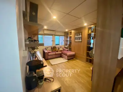 Cozy living room with modern decor and comfortable seating in a stylish apartment.