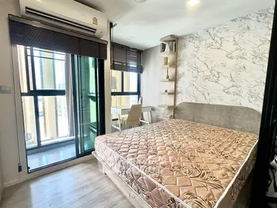 Modern bedroom with balcony access and stylish decor in urban apartment