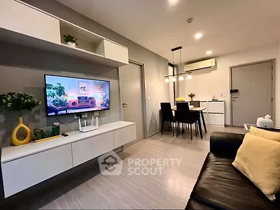 Modern living room with sleek furniture and dining area, perfect for urban living.