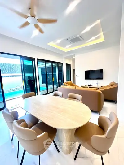 Luxurious modern living room with pool view, elegant furniture, and stylish decor