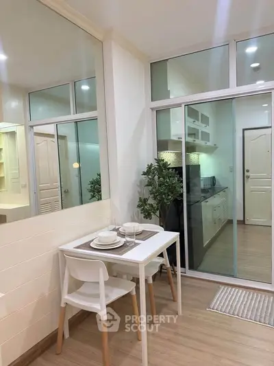 Modern kitchen with dining area and glass partition in stylish apartment