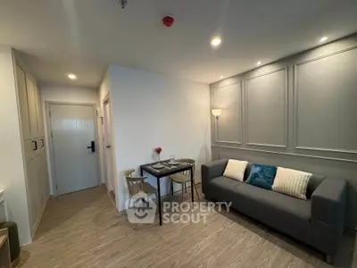Modern living room with cozy gray sofa and dining area in stylish apartment.
