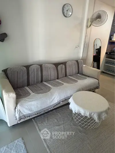 Cozy living room with stylish sofa and modern decor, perfect for relaxation and entertaining guests.