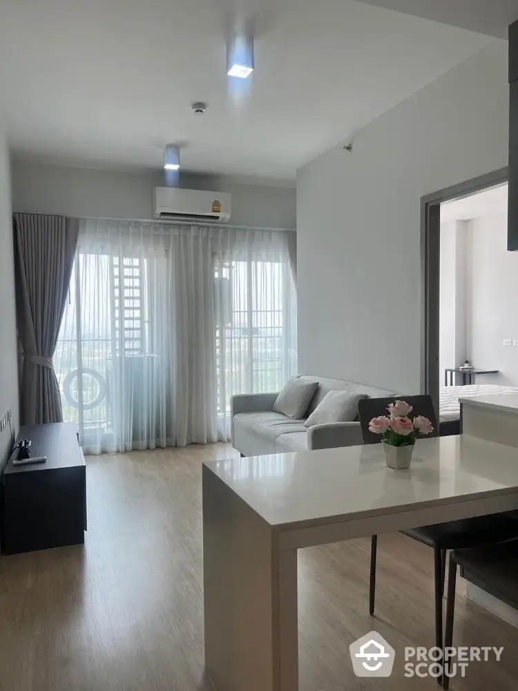 Modern living room with natural light and elegant decor in a stylish apartment.