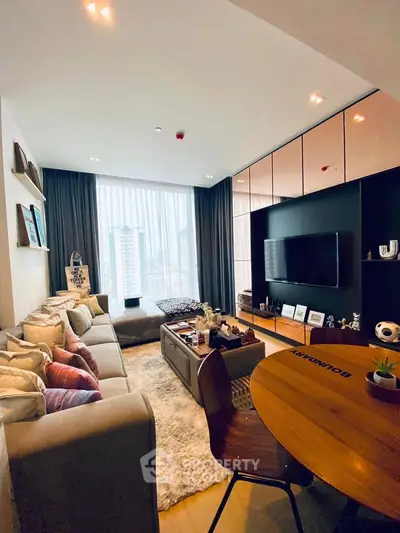Modern living room with stylish decor and city view, featuring cozy seating and entertainment setup.