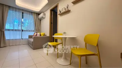 Charming living room with modern decor and bright yellow chairs, perfect for cozy gatherings.