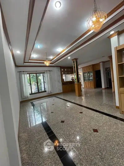 Spacious living room with elegant lighting and polished flooring in a modern home.