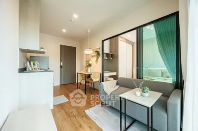 Modern open-plan living room with cozy sofa and dining area in stylish apartment.