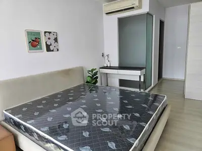 Modern bedroom with minimalist decor and air conditioning in a stylish apartment.