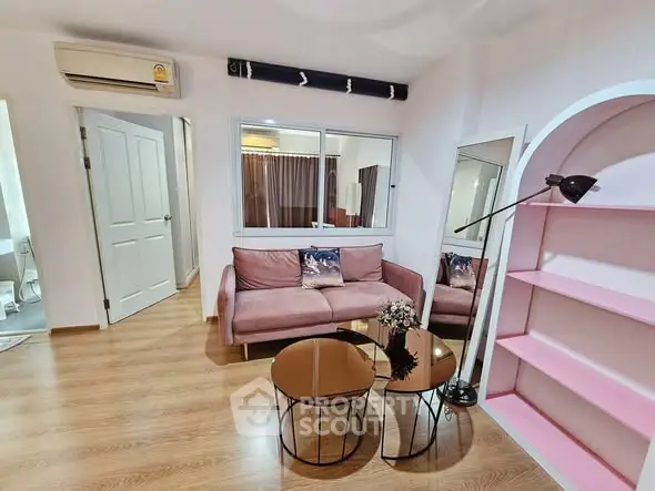 Chic living room with pink sofa, modern decor, and stylish shelving.