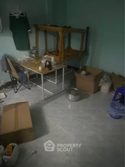 Unfurnished room with tiled floor and scattered boxes, ideal for storage or renovation.