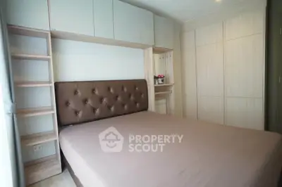 Modern bedroom with stylish built-in storage and elegant headboard in a cozy apartment.