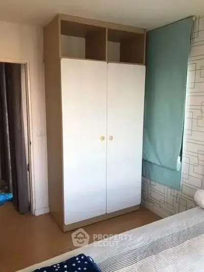 Cozy bedroom with a minimalist wardrobe and stylish decor