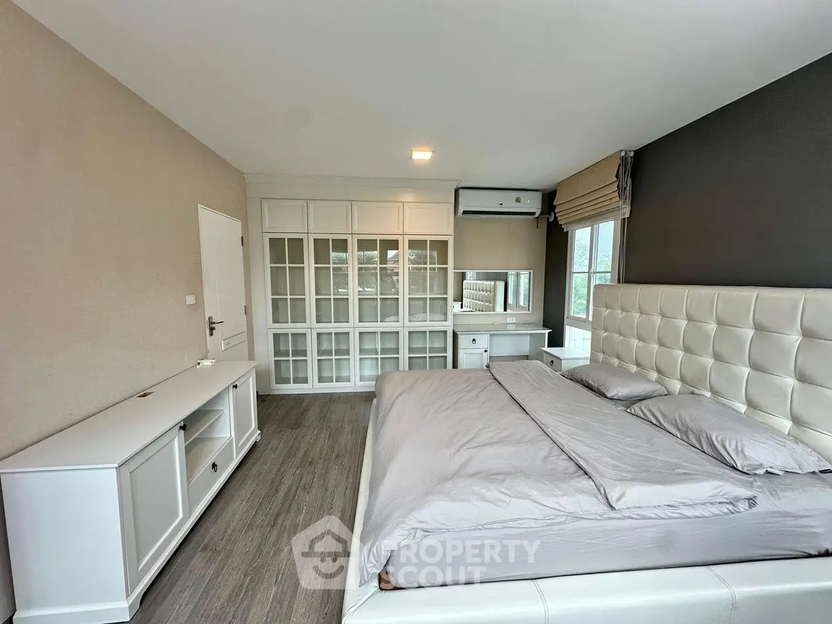 Spacious modern bedroom with elegant decor and large wardrobe