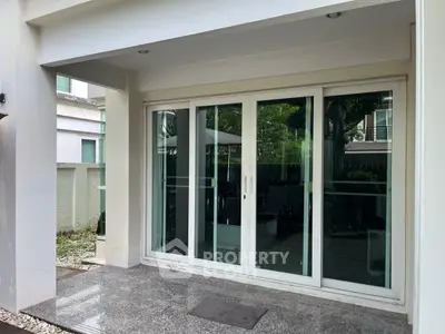 Modern patio with sliding glass doors and garden view
