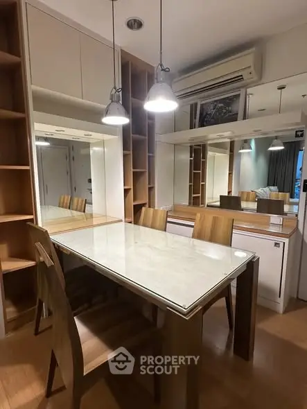 Modern dining area with stylish wooden furniture and elegant lighting