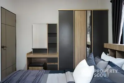 Cozy bedroom with modern wardrobe and stylish bedding in a contemporary apartment.