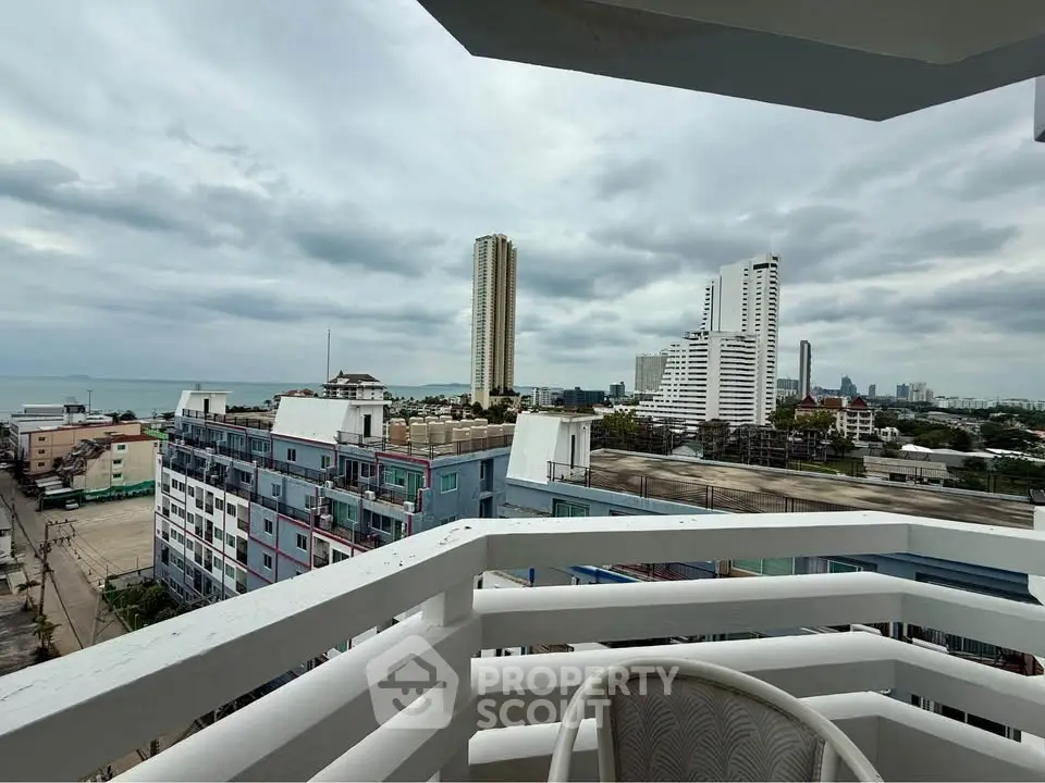 Stunning city and ocean view from a modern balcony in a high-rise building.