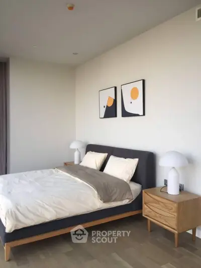 Modern bedroom with stylish decor and minimalist design, featuring a comfortable bed and elegant nightstands.