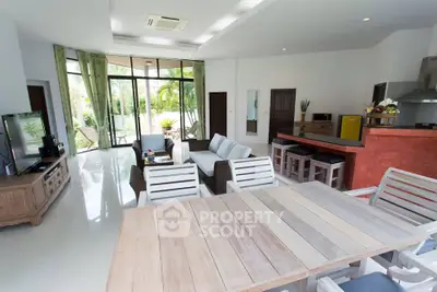 Spacious open-plan living room with modern decor and garden view