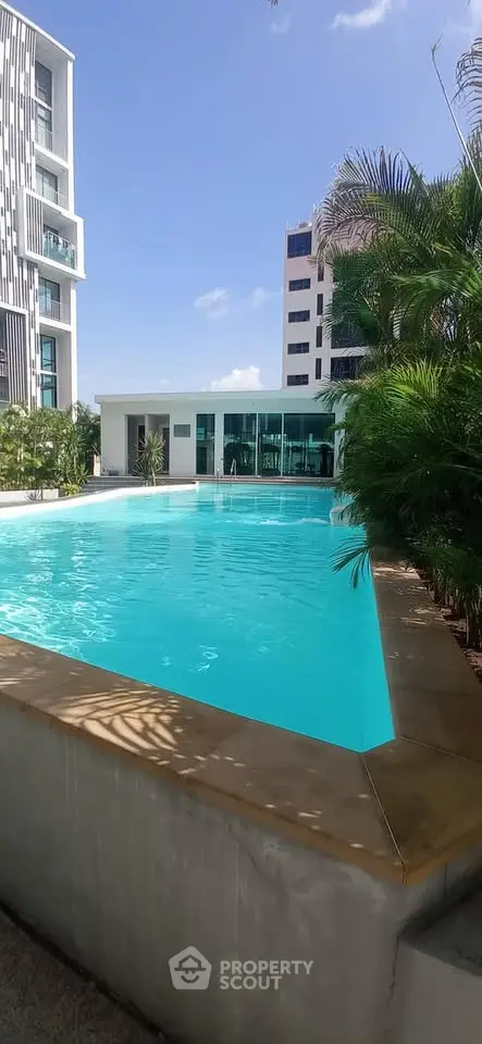 Luxurious residential pool area with modern architecture and lush greenery