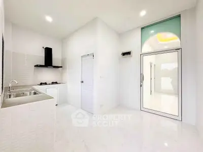 Bright modern kitchen with sleek design and gas stove, perfect for culinary enthusiasts.
