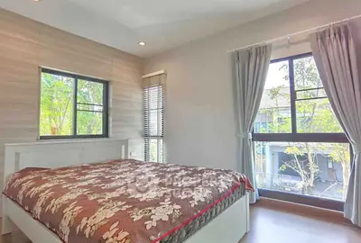 Bright and airy bedroom with large windows and elegant decor