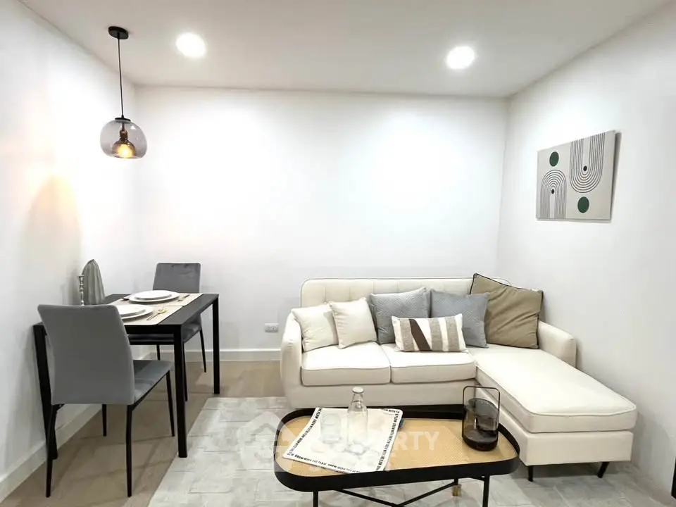 Modern living room with stylish decor and cozy dining area, perfect for urban living.